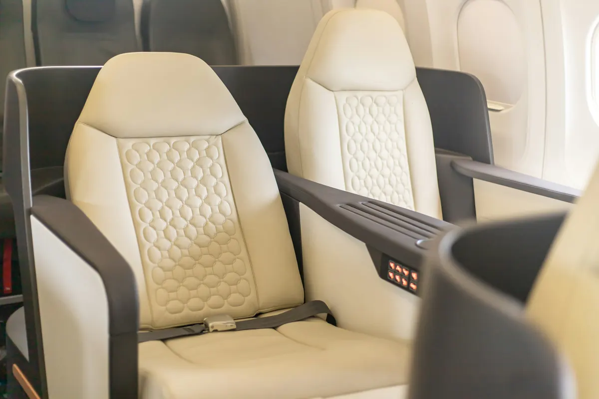 Cream leather seat with quilted stitching in a jet cabin