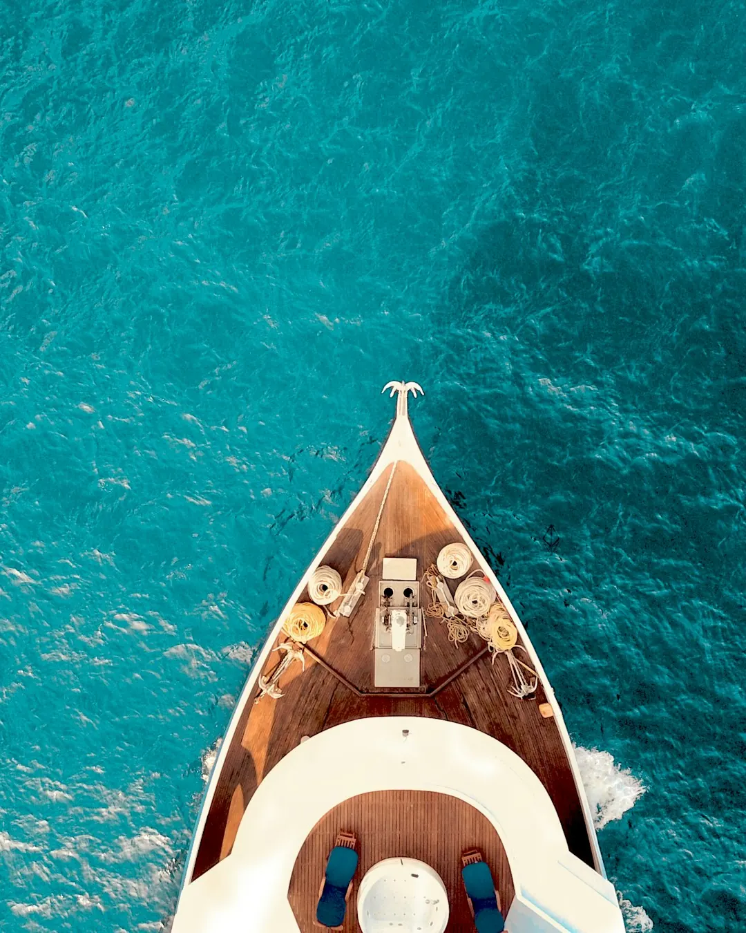 Bow of a yacht over clear turquoise water